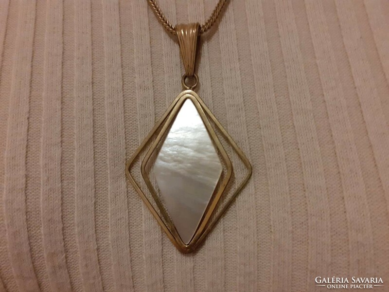 A beautiful copper-colored (or similar) necklace with a mother-of-pearl pendant