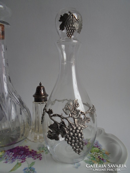 Thin village, glass wine bottle with pewter overlay.