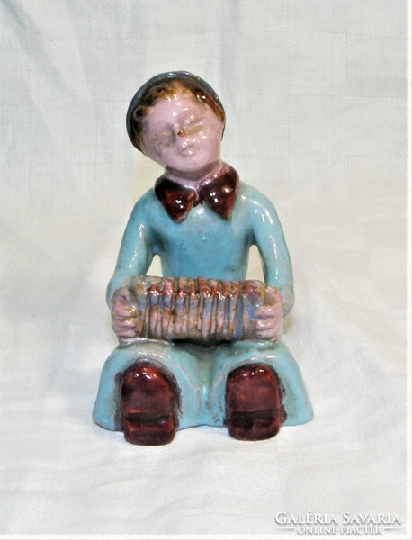 Ceramic figurine of a boy with an accordion