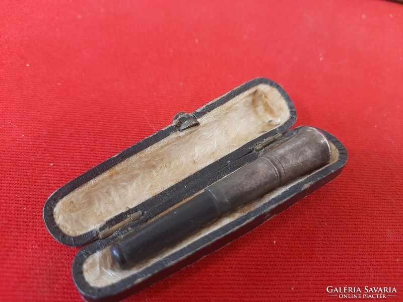 Old marked silver-tipped earring in its box.