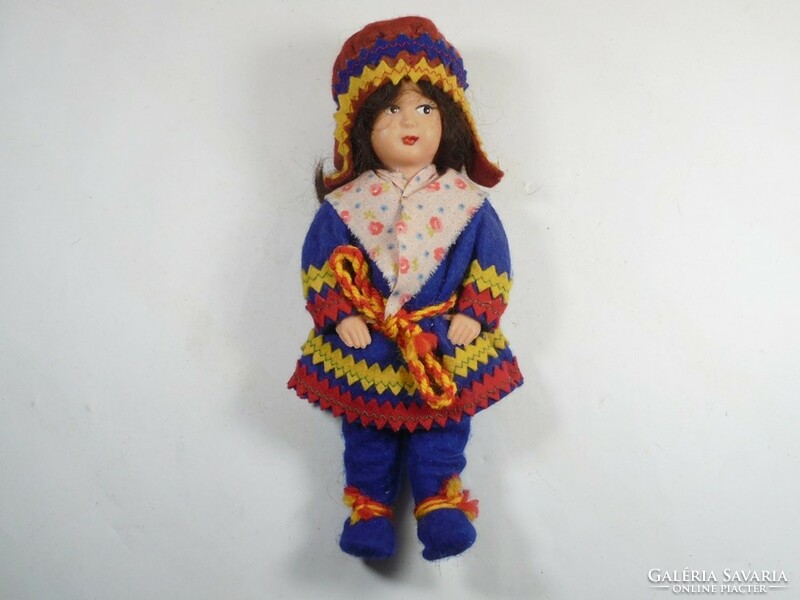 Retro old toy plastic doll in traditional clothes
