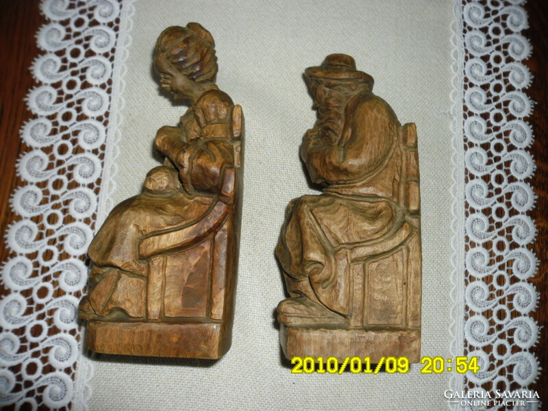 Pair of hand-carved elderly statues