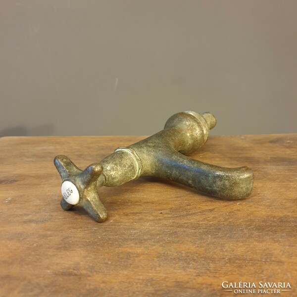 Old thick-walled copper tap with porcelain insert