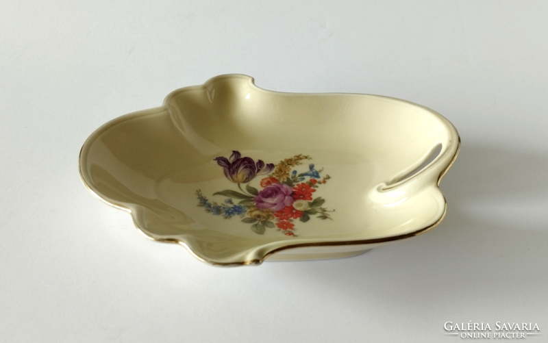 Old beautiful porcelain bowl with a bouquet of spring flowers