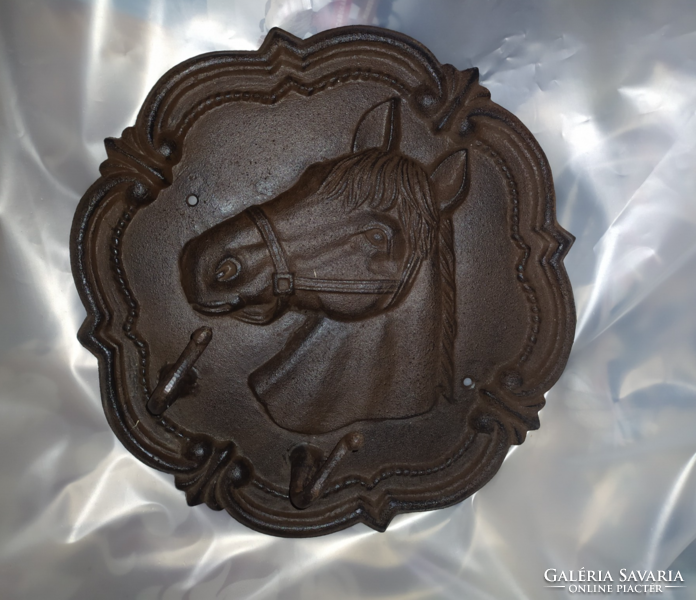 Cast iron wall hanger with a horse head pattern