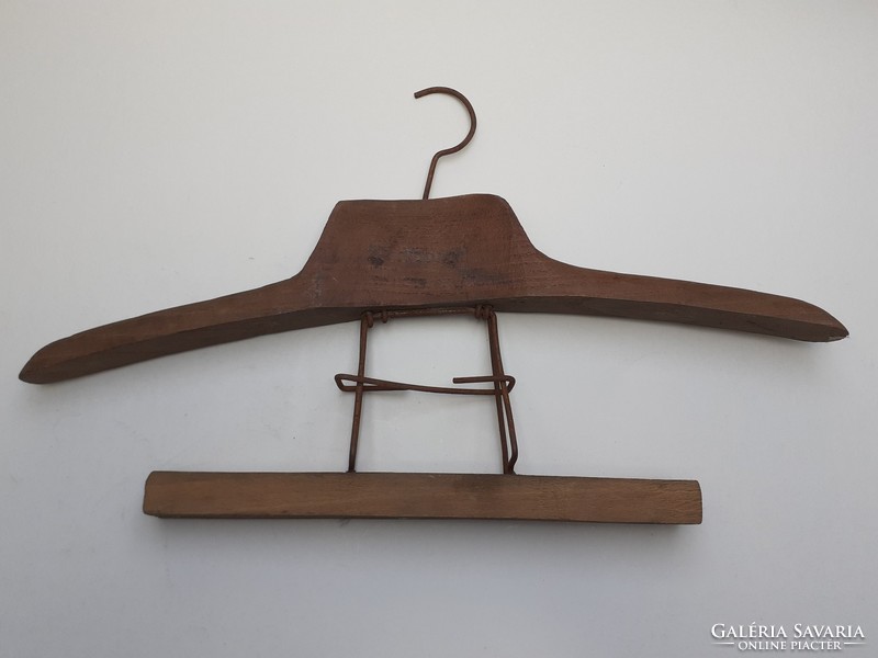 Antique wooden clothes hanger on old clothes hanger in vintage hanging suit holder