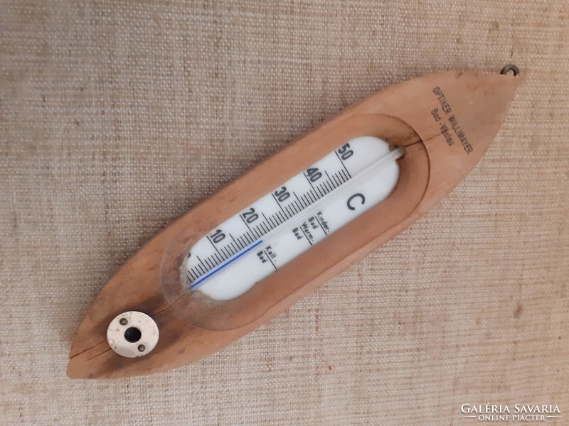 Old wooden boat-shaped thermometer
