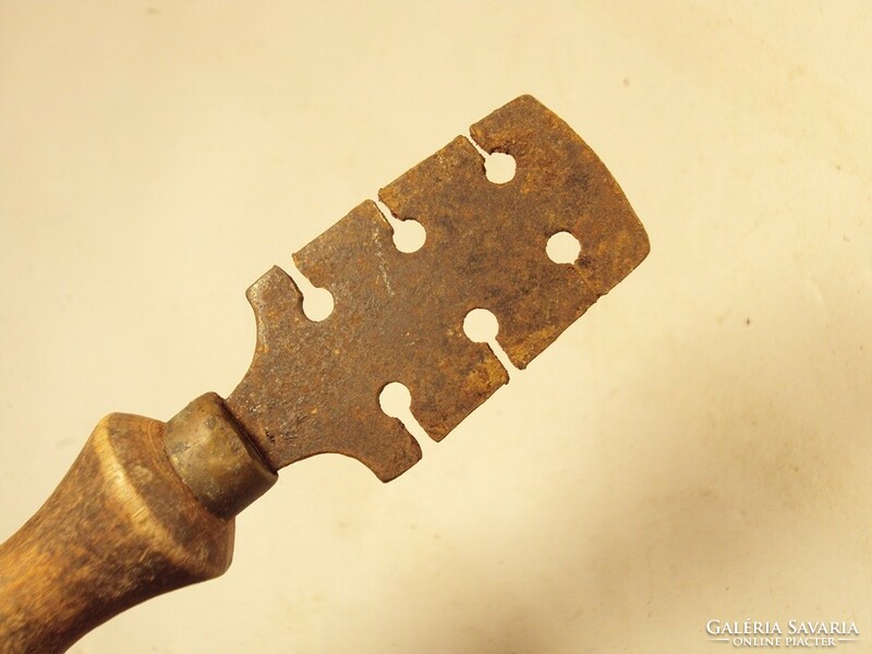 Old saw tooth with folding wooden handle