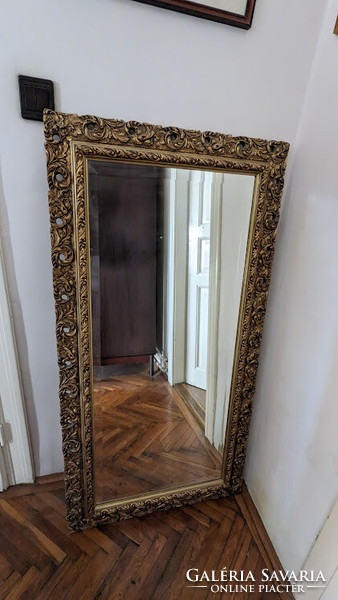 Polished mirror (faceted) in a large, elegant frame.