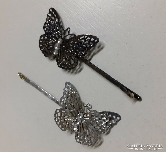 Butterfly-shaped openwork hair clips in new condition, studded with white stones