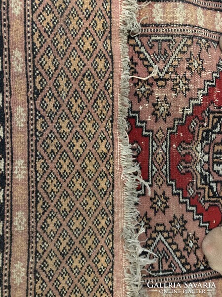 A small, worn Pakistani rug