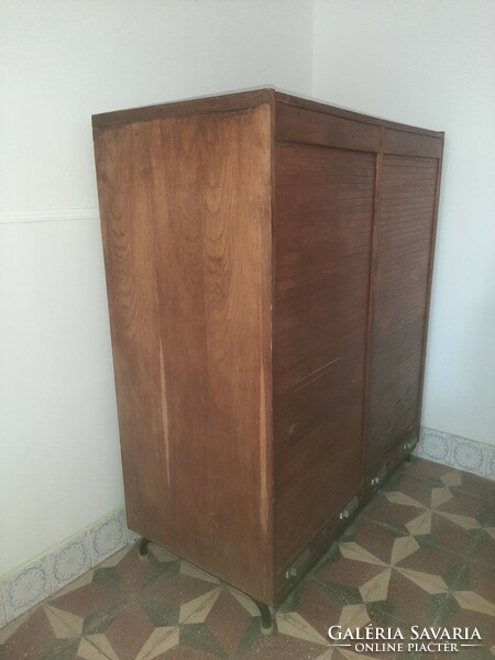 A cabinet with shuttered drawers and index cards