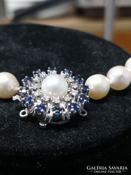Beautiful string of pearls with 14k white gold clasp, sapphire and diamond inlay