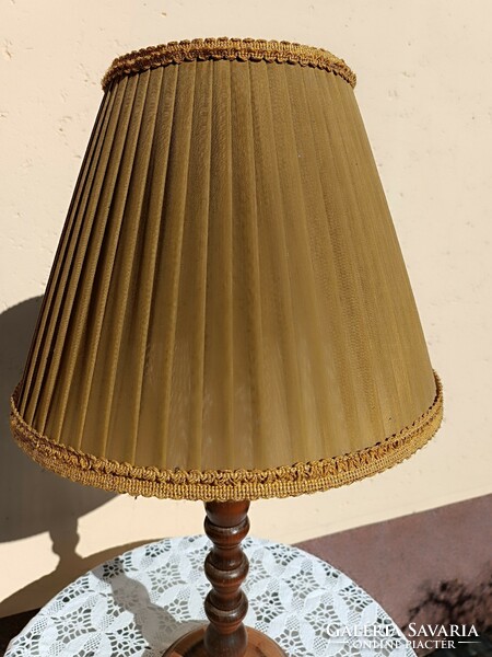 Floor lamp on a wooden base with a textile shade