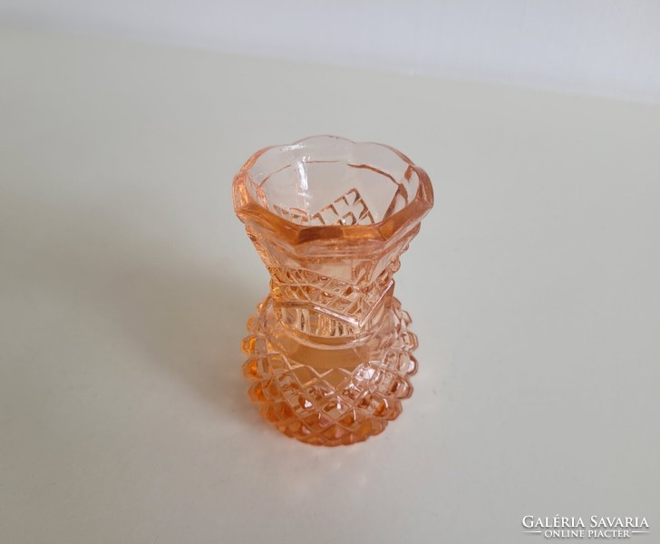Old glass vase in salmon color