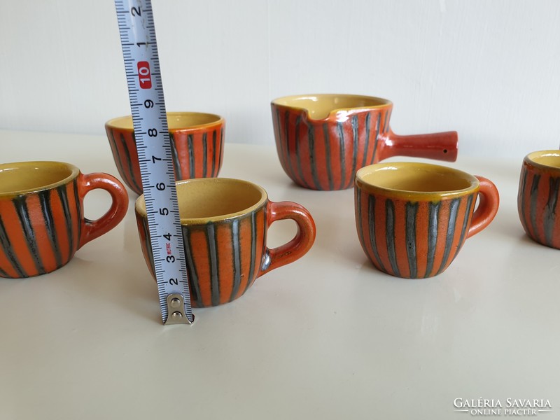 Old retro glazed ceramic coffee set with coffee pourer and coffee cups