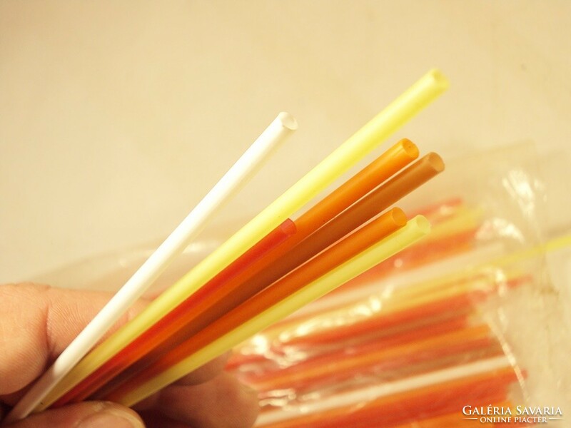 Old retro plastic straw white lemon yellow orange red brown from the 1980s