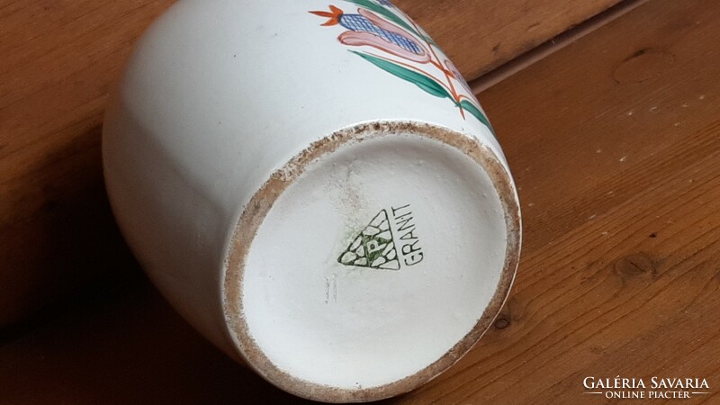 Old granite ceramic bottle with a painted folk motif