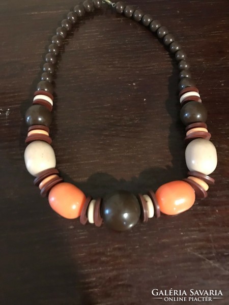 Old, beautiful, colorful, wooden necklace. The orange and brown parts are made of plastic. 52 cm long.