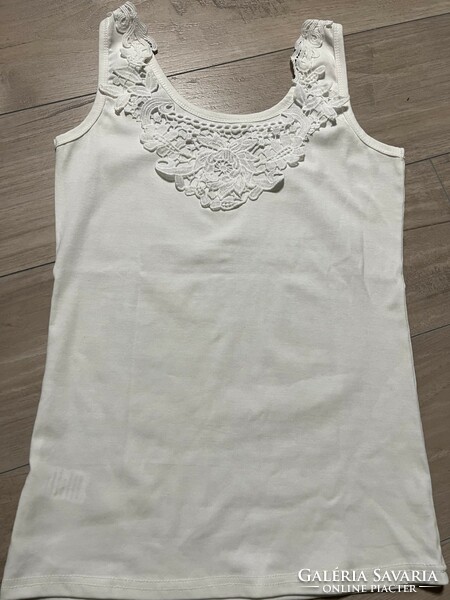 Sleeveless white casual top with a glittery pattern and a lace insert on the back