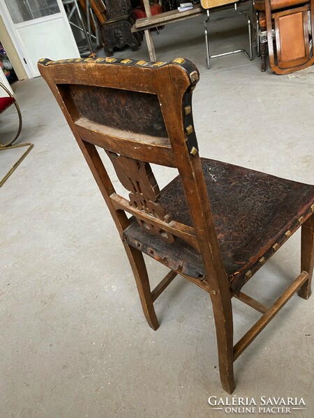 Carved chair with patterned leather seat