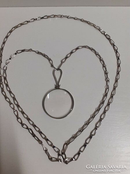 Old neck magnifying pendant on a long necklace in good condition