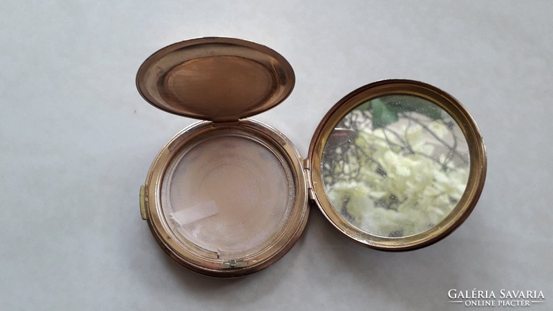 Old metal powder container with vintage powder toiletries