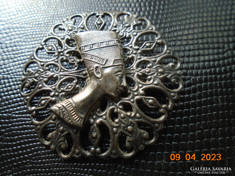 A silver-plated brooch with a relief pattern pierced with a finely crafted profile of Nefertiti