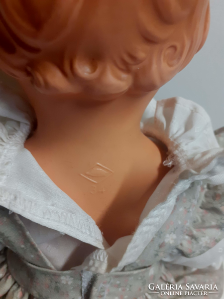 Old rubber doll with a nice face, in a good condition, in a nice dress with a turtle mark on the back