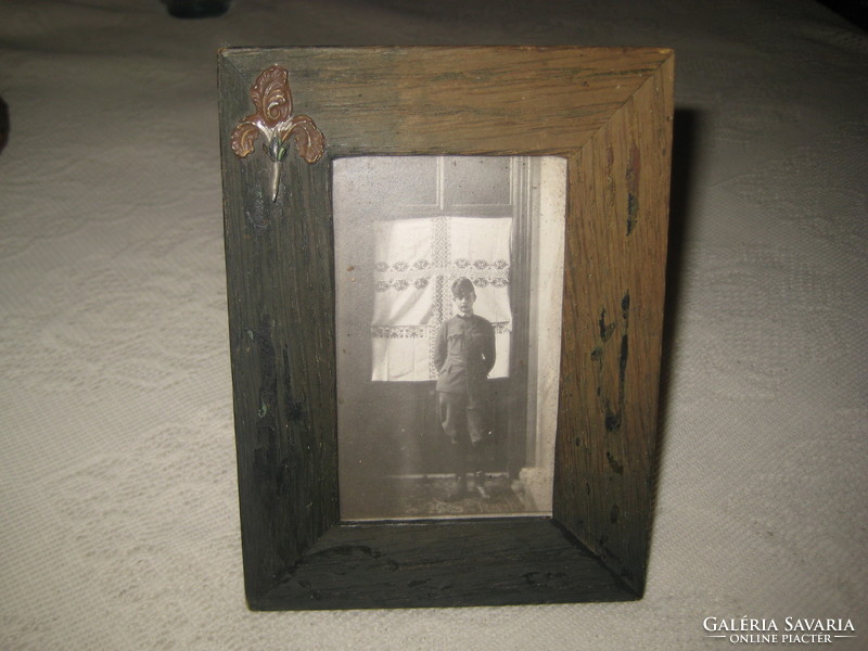 The photo of the little soldier from the 1910s, in a nice wooden frame, covered with leather on the back