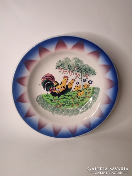 Old painted folk wall plate made of hard earthenware with rooster