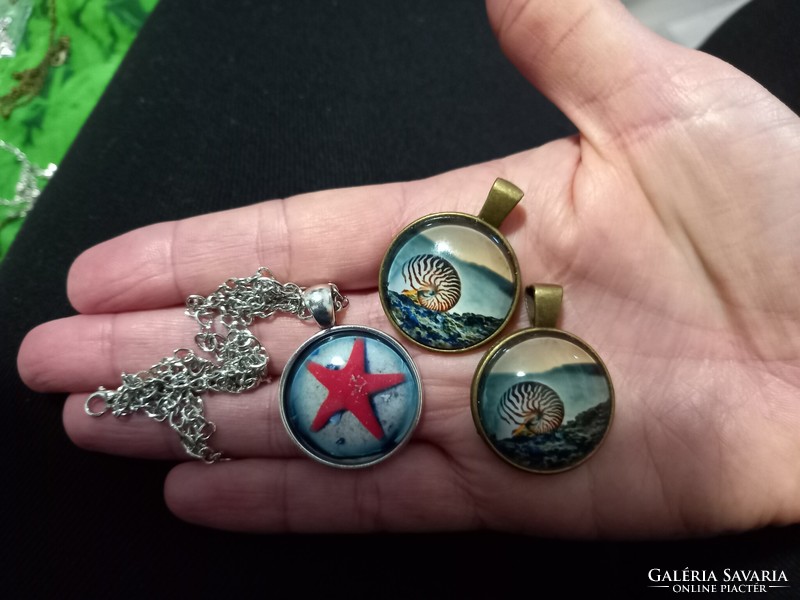 Bronze and silver-plated pendants, amulets with sea animal figures and glass lenses