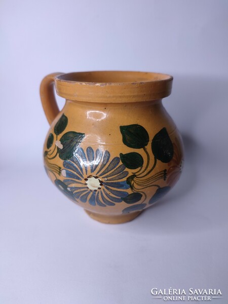 Old small-scale painted folk earthenware pot with silk flowers