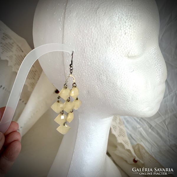 Long beige vintage earrings with hooks, the jewelry is from the 1980s