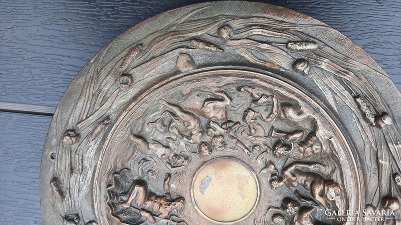 Old bronzed cast iron wall plate with female nude motif