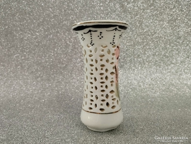 Porcelain candle holder with a pierced pattern