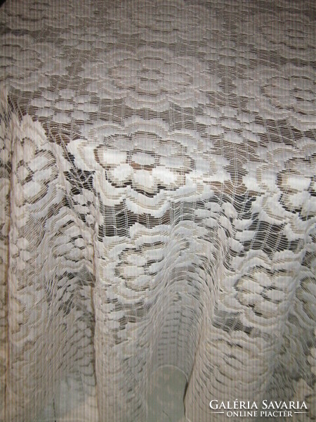 A white and cream curtain richly embroidered in a fabulous vintage-style material