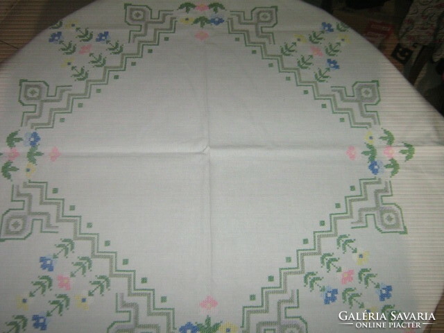 Beautiful floral tablecloth embroidered with colorful cross stitches