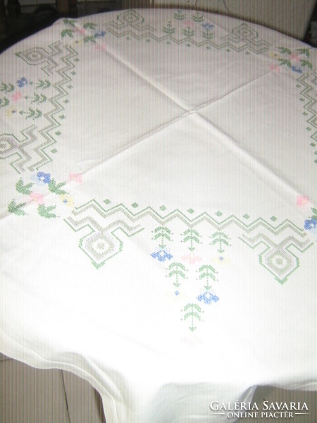 Beautiful floral tablecloth embroidered with colorful cross stitches