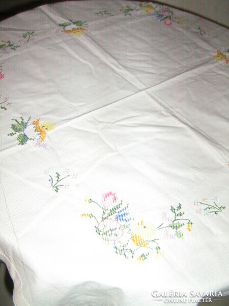 Beautiful hand-embroidered white tablecloth with cross-stitch flowers