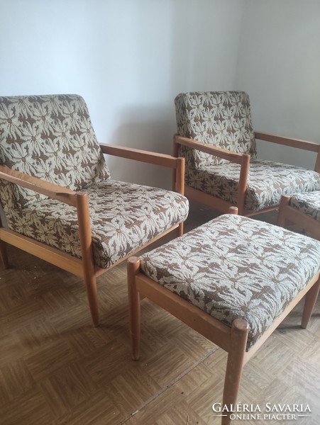 An armchair made in retro style with a pair of footrests
