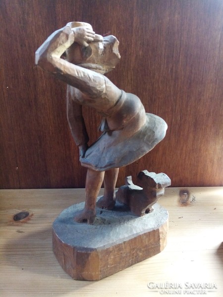 Wooden sculpture, against the wind (in the style of Marilyn Monroe), with a dog
