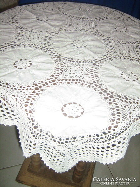 A beautiful tablecloth with hand-crocheted edges and crocheted inserts with Art Nouveau features