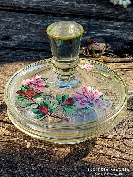 Glass bowl holding lemon rings with a painted lid.