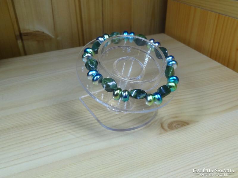Bracelet made of multiple and beautiful colored flat glass beads and twisted beautiful acrylic beads.
