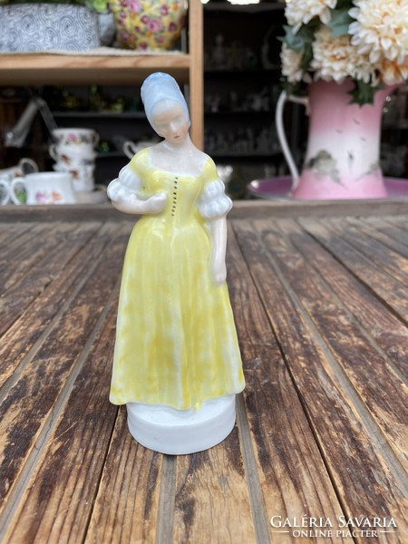 Óherendi porcelán sárga ruhás lány