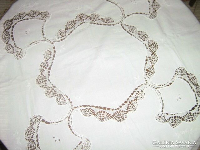 A white filigree tablecloth with a dreamy lace edge sewn insert is a specialty
