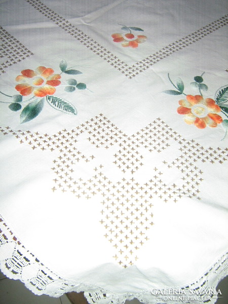 Hand-embroidered white linen tablecloth with a beautiful color scheme and a lace edge