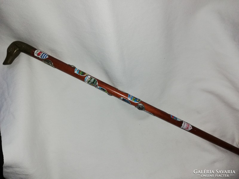 Bronze walking stick with a dog's head, with 16 hiking labels