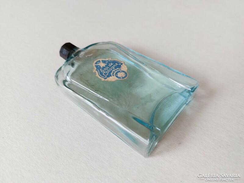 Old perfume bottle with blue cologne bottle label
